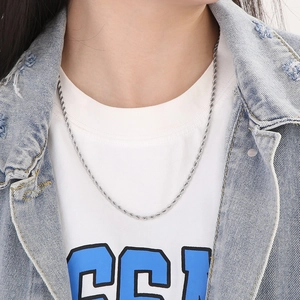 Silver stainless steel twist rope chain necklace worn by model for casual style
