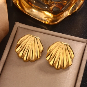 Detail of 18K gold-plated shell-shaped stud earrings with vintage ribbed texture on stand
