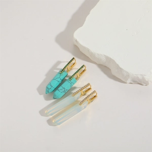 Macro detail of copper earrings with natural turquoise and opal stones in 18k gold plating