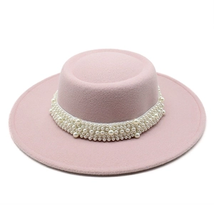 Elegant pink wool felt boater hat for women featuring a wide brim and pearl band