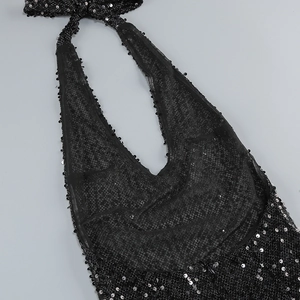 Close-up of black sequin halter neck and deep V-neckline details on evening dress