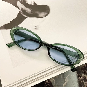 Retro oval sunglasses in translucent dark green frames with light blue lenses for women