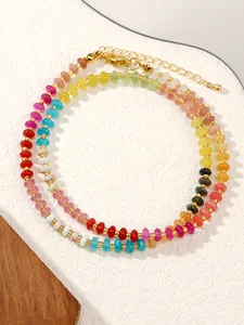 Detailed macro shot of gradient crystal bead necklace with gold lobster clasp and extension chain