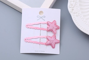 Detail of pink glitter star hair clips for girls set on white display card
