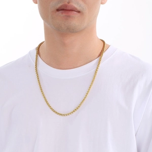 Close-up of 6mm golden stainless steel basket weave chain necklace on a male model