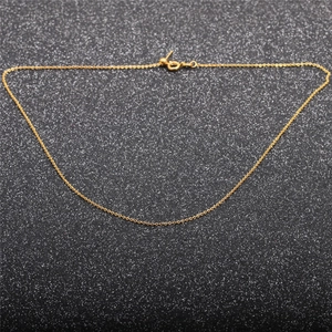 Elegant gold thin link necklace with spring clasp over a dark textured glitter background