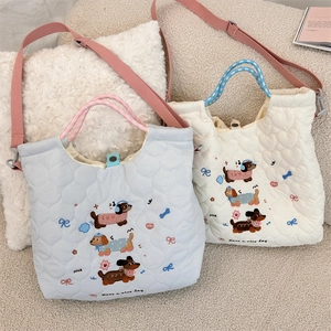 Detail of embroidered dachshund pattern and quilted fabric on the cute crossbody bag