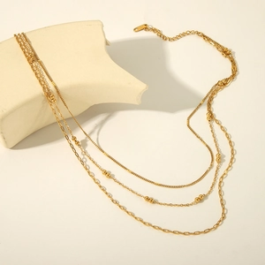 Three-layer gold stainless steel necklace with bead details and stacked chains for women