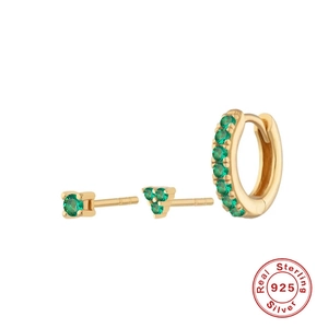 Detail of three-piece 925 silver earring set with emerald green stones and gold plating
