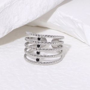 Detail of minimalist silver multi-layer open ring with four black circular beads