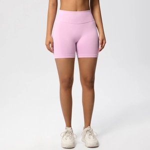 Macro detail of the high-waisted seamless peach lift sports shorts in light pink fabric