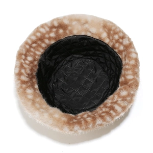 Detail of warm faux fur bucket hat with deer print and black quilted lining for winter
