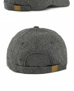 Detail of wool baseball cap back showing brass buckle and textured grey fabric