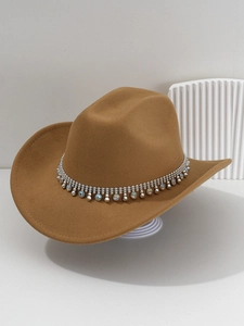 Macro view of silver beads and iridescent rhinestones on a camel brown cowboy hat band