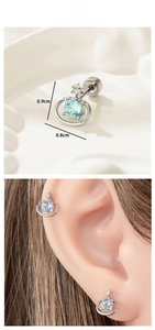 Macro shot and model view of silver Saturn stud earrings with blue cubic zirconia