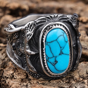 Detailed close-up of retro silver ring with turquoise stone and floral carvings