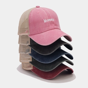 Stack of colorful mesh trucker hats featuring Mommy embroidery and vintage washed texture