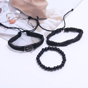 Detailed view of 3-piece set featuring tree of life charm leather and beaded bracelets