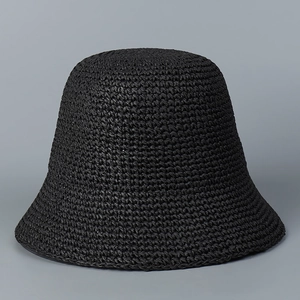 Close-up of tight weave pattern on a black handmade straw bucket sun hat for women