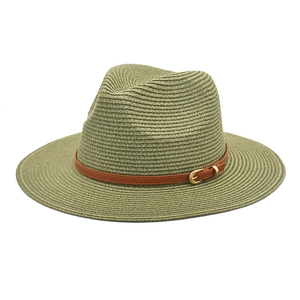 Detail of summer straw panama hat with a green weave and brown leather belt buckle