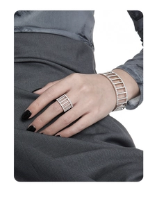 Detailed close-up of a silver lattice cuff bracelet with sparkling pavé cubic zirconia