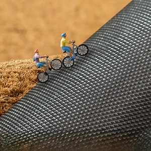 Detail of PVC anti-slip backing with gray grid texture on a coir doormat