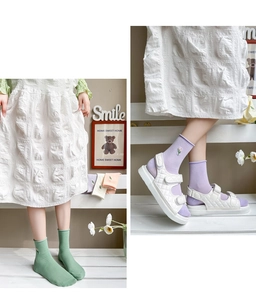 Detail of cotton crew socks with floral embroidery paired with white platform sandals