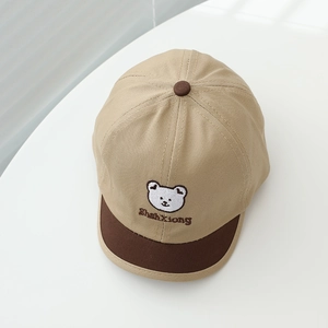 Close-up of baby baseball cap with bear embroidery and contrast brim in khaki brown