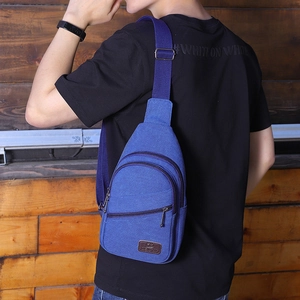 Men's navy blue canvas chest bag with adjustable strap and multiple zipper pockets