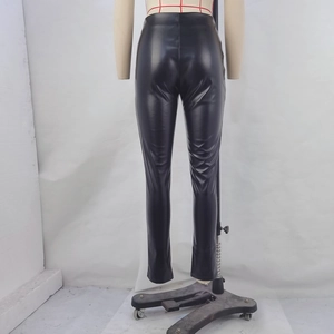 Detail of high waisted black PU leather pants showing slim fit lifting effect from behind