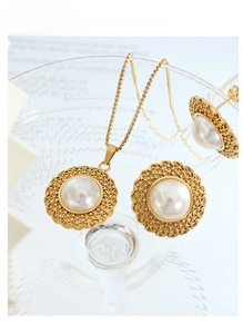 Macro view of vintage gold straw hat design necklace and pearl earrings set