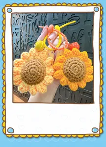 Detailed close-up of handmade crocheted sunflower keychains in yellow and orange colors.