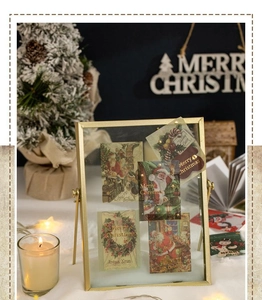 Macro detail of vintage Christmas stickers with gold foil displayed in a metal rotating frame