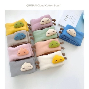 Macro shot of soft knit baby scarves featuring 3D plush cloud embroidery in macaron colors