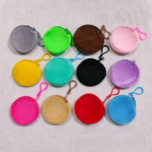 Detailed overhead view of twelve colorful plush round mini wallets with plastic hooks