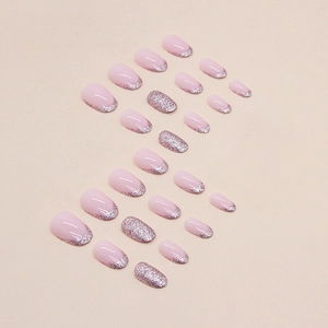 Pink almond press-on nails with silver glitter French tips and sparkling accents