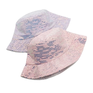 Detail of pink and purple sequined bucket hats with shimmering woven fabric texture