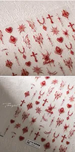 Detailed macro view of 5D embossed gothic nail stickers with red hearts and spider webs