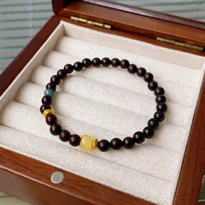 Blue crystal and amber sandalwood beaded bracelet displayed in a premium wooden box