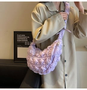 Detail of light purple quilted velvet cloud bag showing plush texture and strap