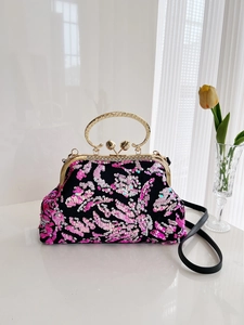 Sequin shell handbag with floral patterns, gold hollow handle, and rhinestone clasp detailing