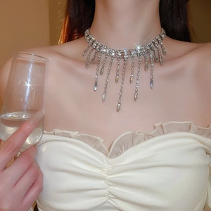 Macro view of silver tassel choker necklace with shimmering rhinestones on a model