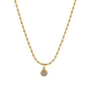Vintage gold bead necklace with a round light blue gemstone pendant for women