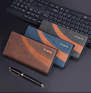 Mens long business wallets in brown, blue, and grey displayed with office accessories