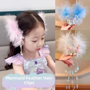 Detail of mermaid feather hair clips featuring sequins, faux pearls and beaded tassels