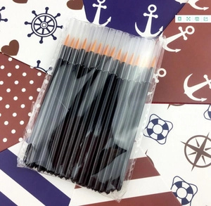 Detailed shot of disposable eyeliner brushes with black handles and orange nylon bristles