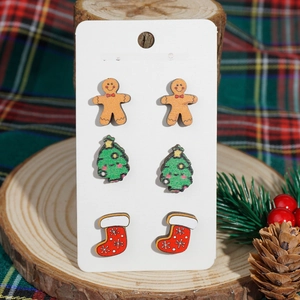 Christmas earrings set featuring gingerbread man, tree, and sock on festive background