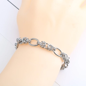 Detail view of silver stainless steel multi-link bracelet on female wrist