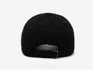Detail view of black faux lamb wool baseball cap with an adjustable metal buckle