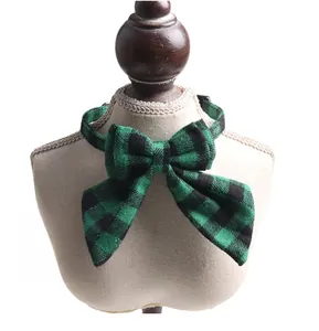British style green and black plaid pet bowtie collar displayed on a white model